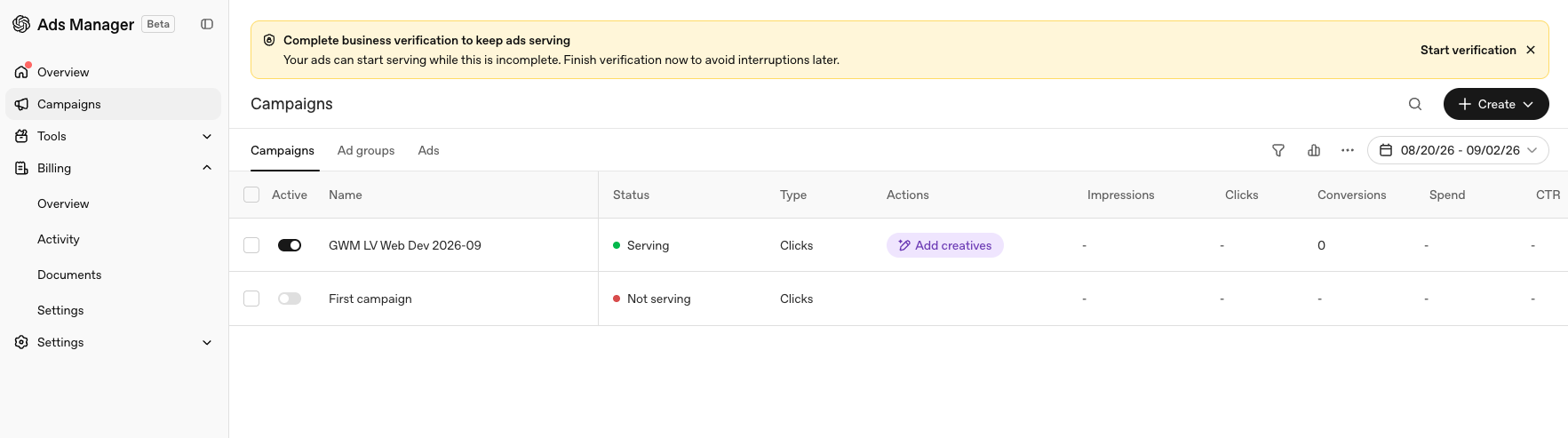 The Ads Manager campaign list showing a campaign with the status Serving while the banner still asks for business verification